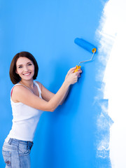 Happy woman brushing the wall