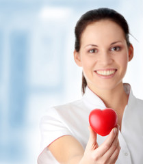 Young nurse with heart in her hand