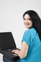 Happy woman using laptop