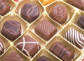 assortment chocolate pralines in a golden box