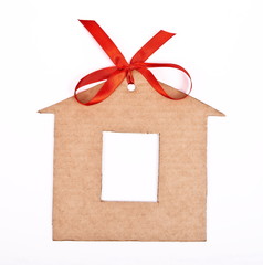 Cardboard house with red ribbon and bow