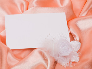 White card for congratulation, flowers from silk on a background