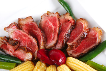 meat served on white with corns
