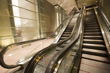 escalators in a building in hong kong at night