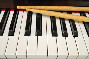 Drum sticks on piano keyboard