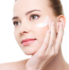 woman applying cosmetic near eyes