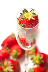 Strawberries in a glass on white background