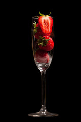 Strawberries in a glass on black background