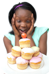 Astonished young woman looking at cakes