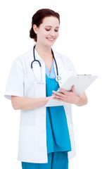 Obraz premium Charming female doctor making notes in a patient's folder