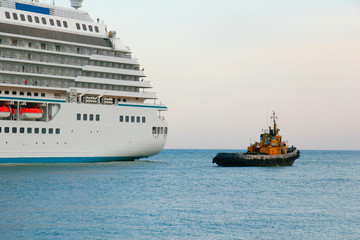 Large liner and small tugboat