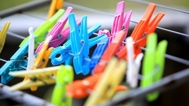 random colorful clothes pegs moved by the wind