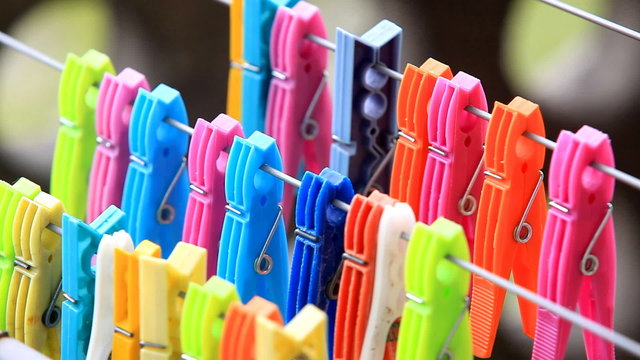 rows of colorful clothes pegs moved by the wind