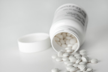 Prescription pills with container in the background