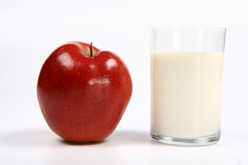 Apple and a glass of milk on white background