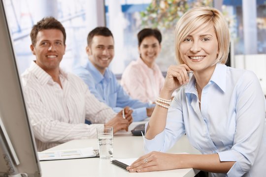 Happy businesswoman in boardroom