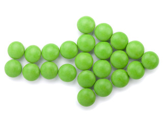 green tablets in arrow formation, isolated on white background