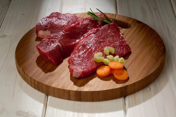 beef steak with ingredients over cutting board