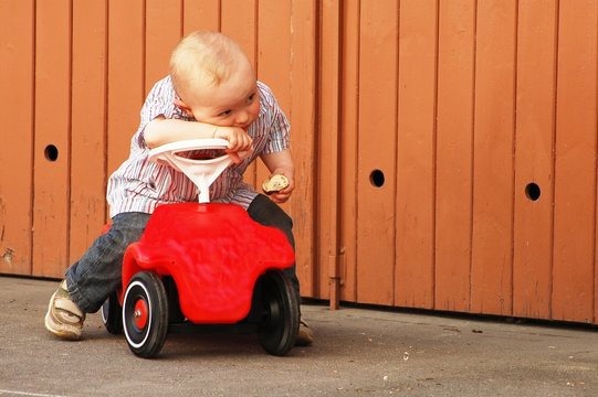 Child with  red car
