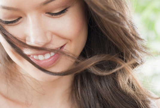 Mixed race woman looking down and smiling