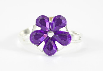 Purple costume jewelry ring on white background