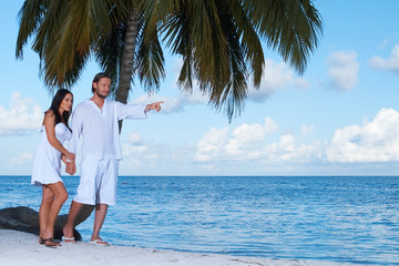 Couple nex to Palm tree