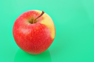 Juicy red apple on green