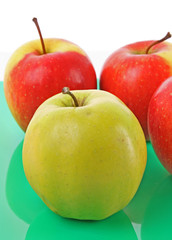 Juicy red apple on green