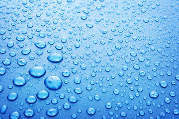 Blue water drops background with big and small drops
