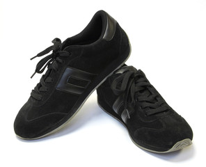 Black running shoes on a white background