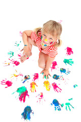 Obraz na płótnie Canvas Cute little girl making hand prints. Isolated on white.