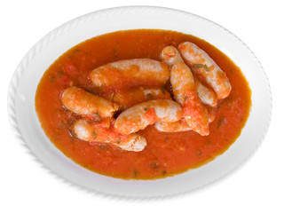 Sausages in tomato sauce on white dish.