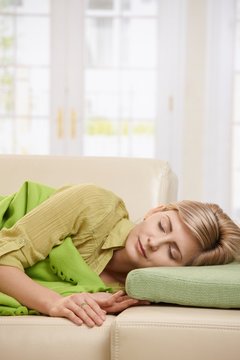 Blond woman sleeping on couch