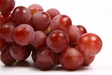 Red grapes in close up on white background