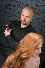 Fototapeta na wymiar Professional hairdresser with fashion model at luxury salon