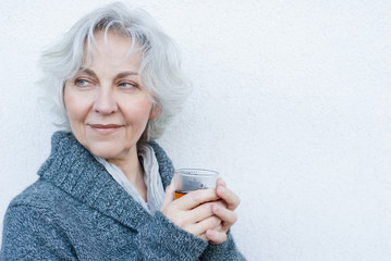 attractive mature woman with a glass of tea