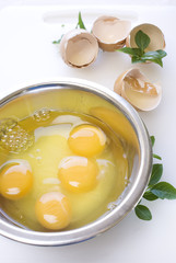 Eggs in the metal bowl with leafs