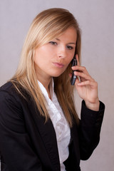 Disappointed business woman with mobile phone