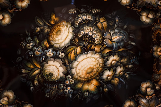 Black tray painted with floral patterns. Russian national crafts