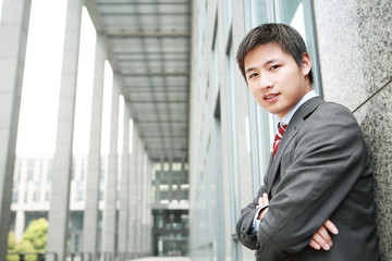 Fototapeta premium a yong Asiatic businessman is standing outdoor