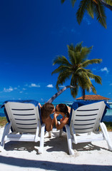 Couple nex to Palm tree