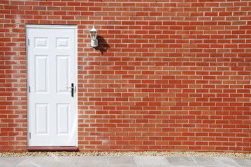 White door on a brick wall