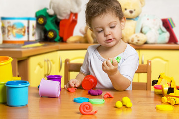 Little child playing plasticine