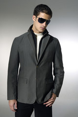 Portrait of young trendy male model wearing sunglasses