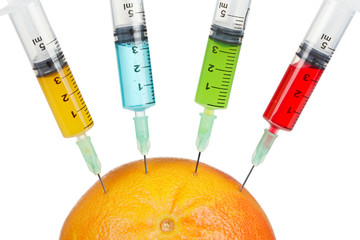 Grapefruit with four syringes