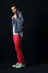 young man posing on black background