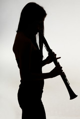 shadow of a woman clarinet player - obrazy, fototapety, plakaty