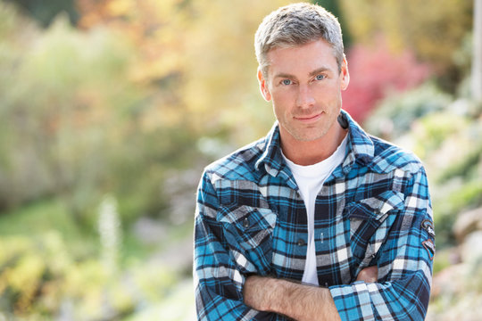 Portrait Of Man Standing Outside In Autumn Landscape