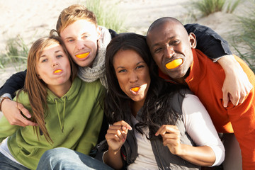 Group Of Friends Pulling Funny Faces On Beach