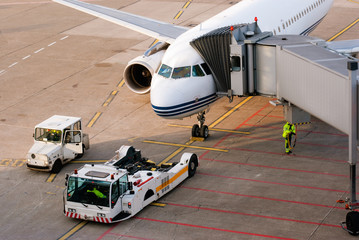 Airport. Airplane is being serviced by the ground crew.